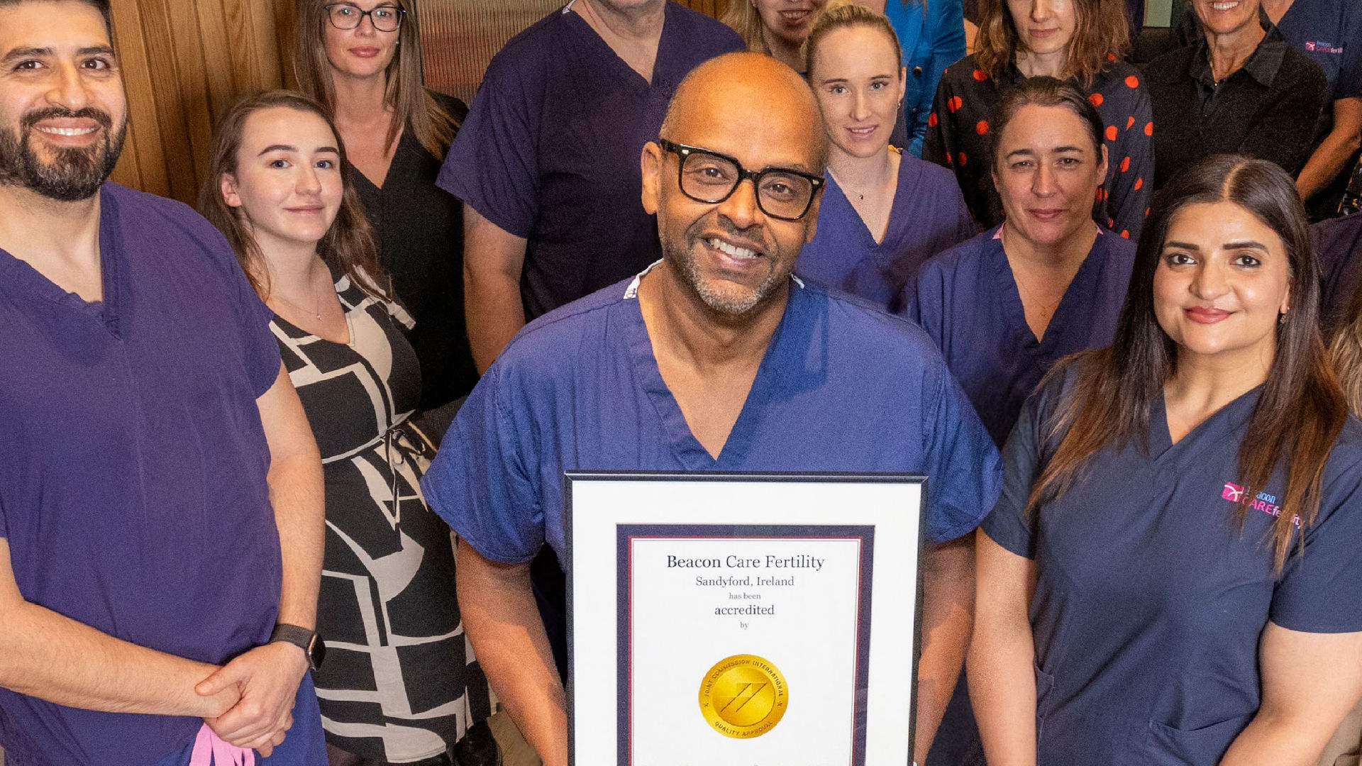 White male and female couple, sitting in an appointment room smiling.